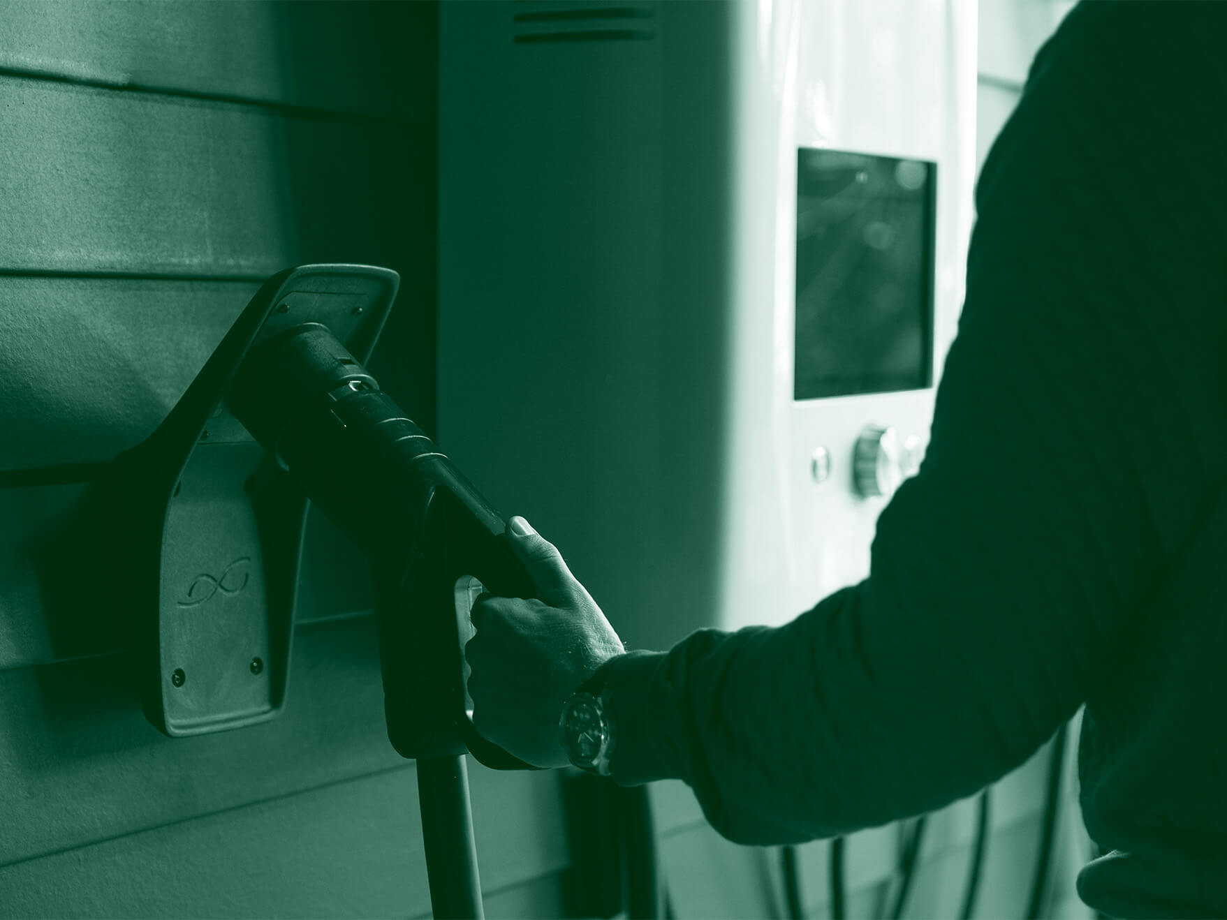 An EV car user reaching out to a charger